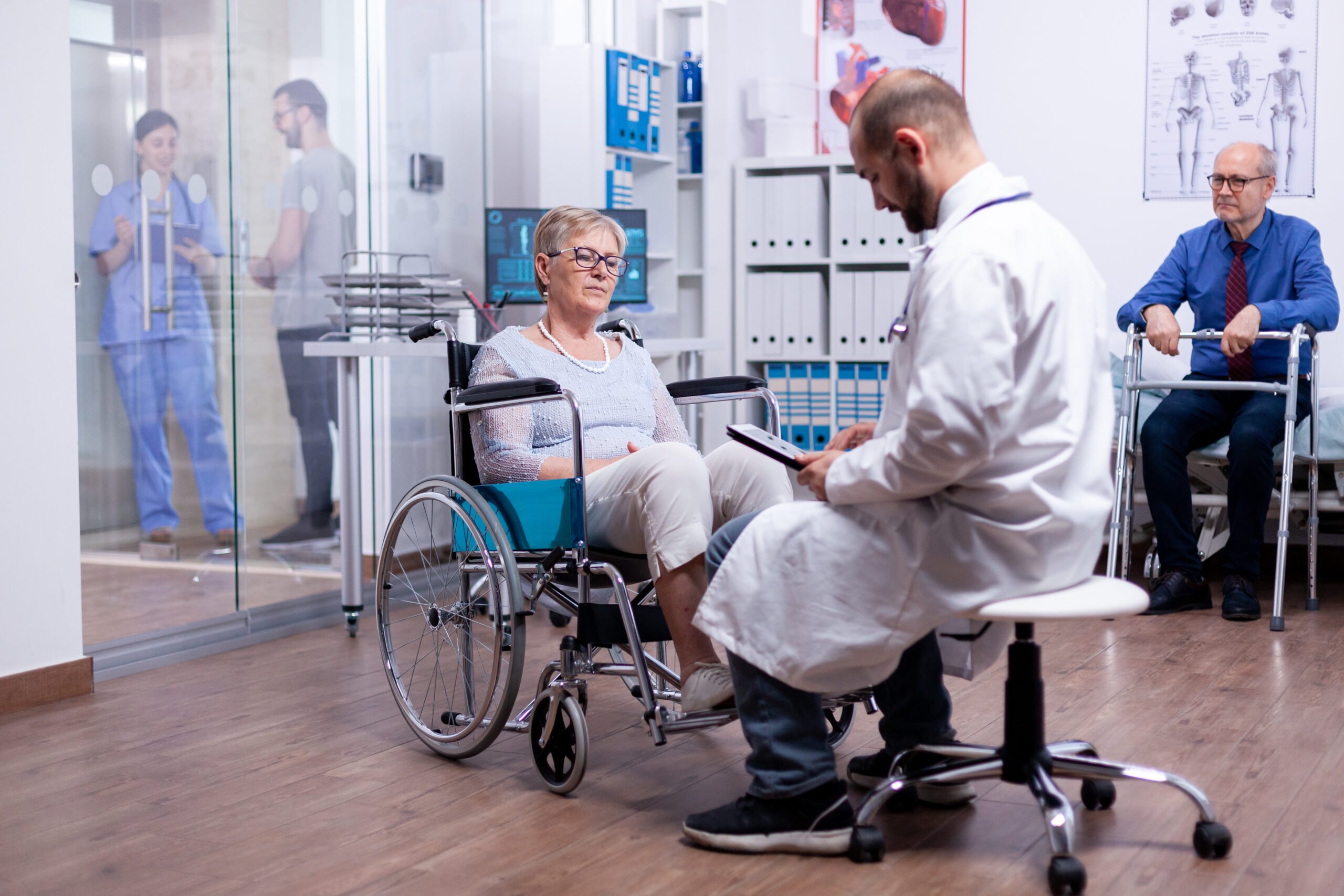 woman with parkinson sitting wheelchair hospital room during medical examination scaled