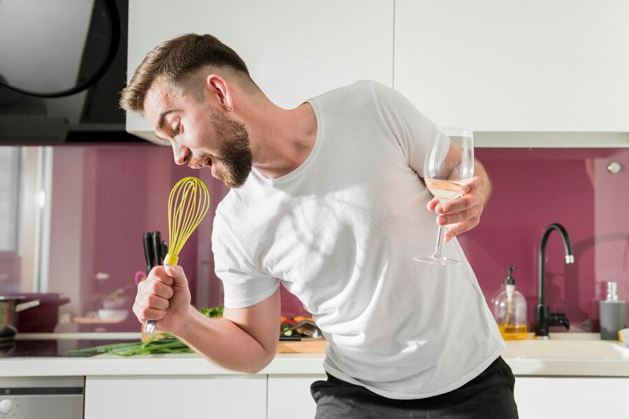 man using whisk as microphone 23 2148593239