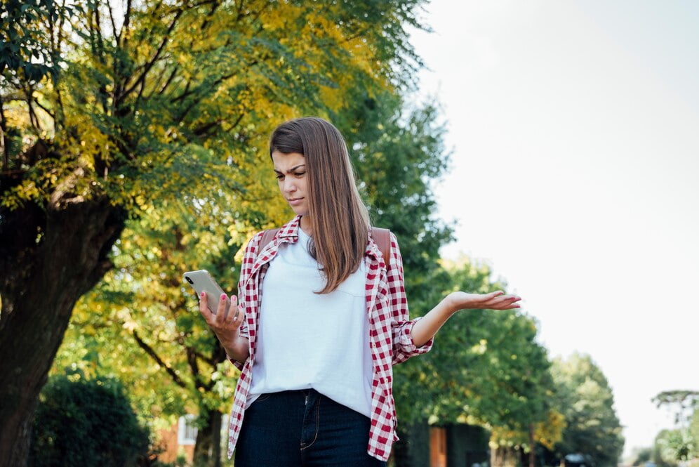 young girl surprised while checking her phone 23 2148206778