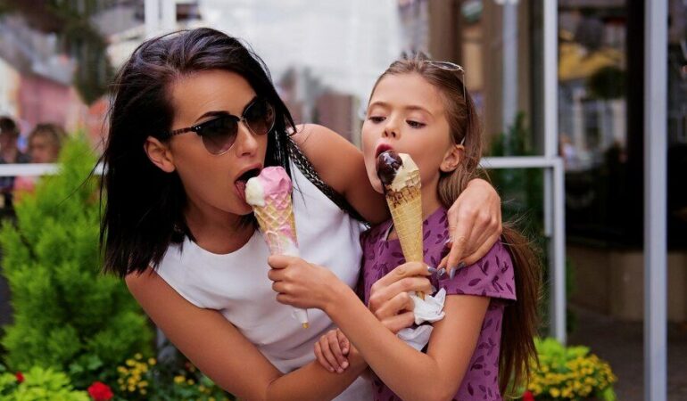 -girl-eating-ice-cream-street_613910-12186