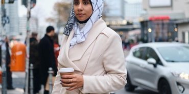 young-attractive-arabic-woman-hijab-dreamily-walking-around-city-street-with-coffee-go_574295-2983