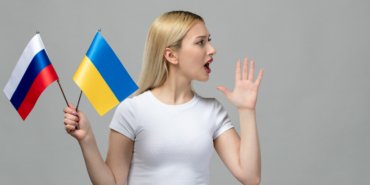 ukraine-russian-conflict-blonde-cute-girl-holding-russian-ukrainian-flag-yelling-someone